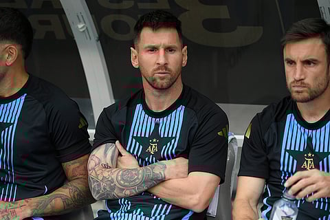 Messi looks on from the bench